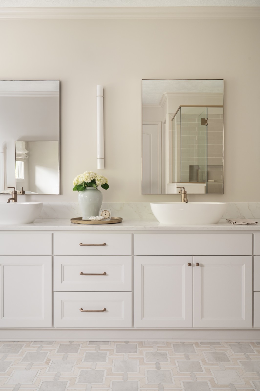Double sink vanity with mirrors and brass hardware in Michiana primary bathroom remodel