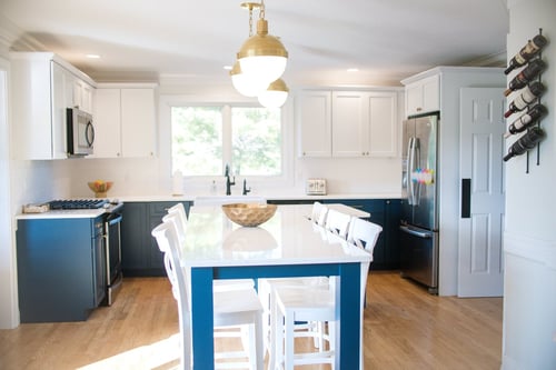 Big L kitchen island with blue lower cabinets and white upper cabinets in Greater Michiana