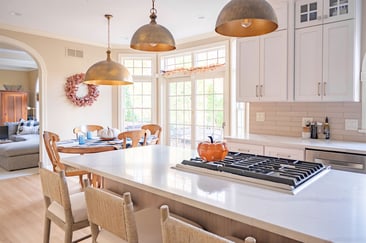 Bright kitchen and dining area in Bristol, IN, featuring white cabinetry and large windows
