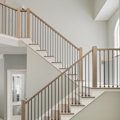 Bright staircase in Granger, IN with light wood railings, black balusters, and white trim