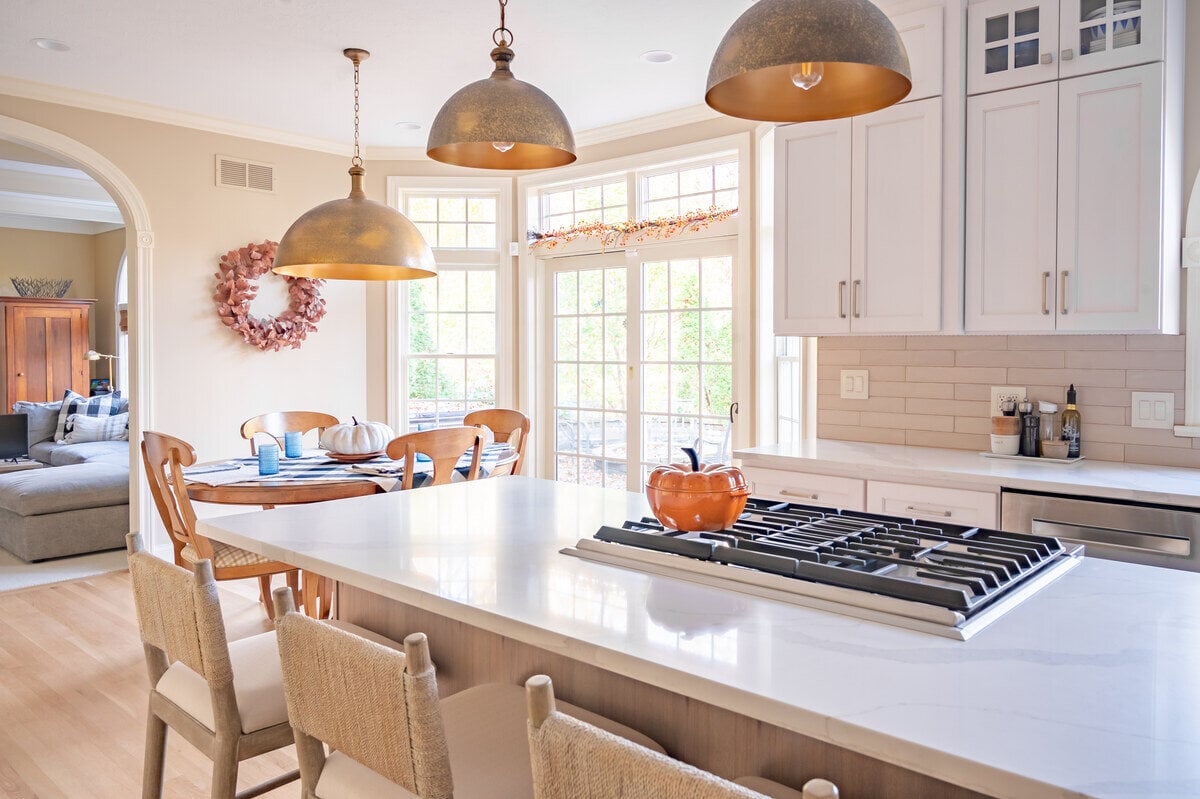Island in kitchen remodel with natural light coming in from windows in South Bend home remodel by Peacock and Company