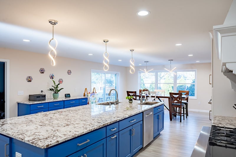 Kitchen island in South Bend addition with pendant lighting above by Peacock & Company