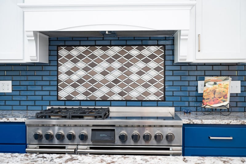 Mosaic backsplash behind stainless steel stove in South Bend kitchen and home addition by Peacock and Company