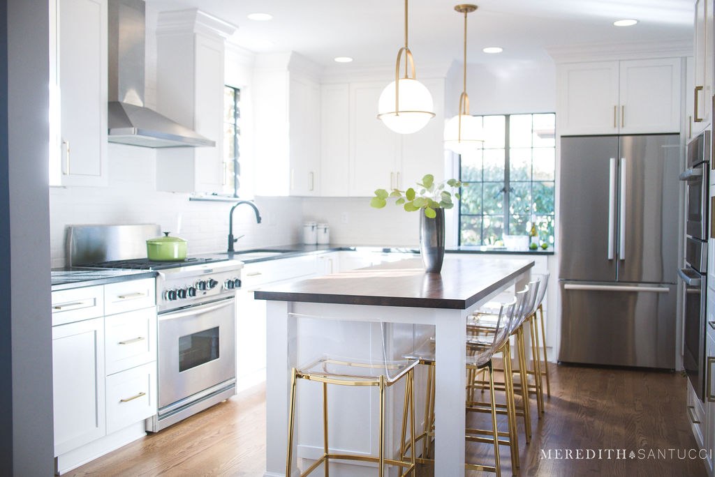 Modern kitchen remodel island and seating beneath hanging light fixtures