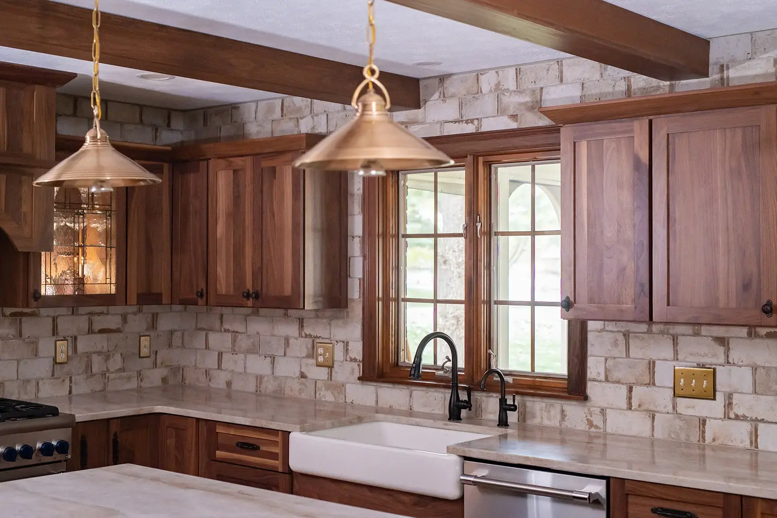 Craftsman-style kitchen remodel in South Bend with rustic brick backsplash