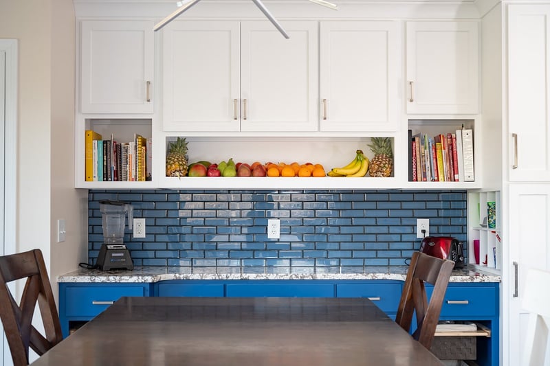 Custom cabinetry and backsplash in two-tone kitchen remodel by Peacock and Company