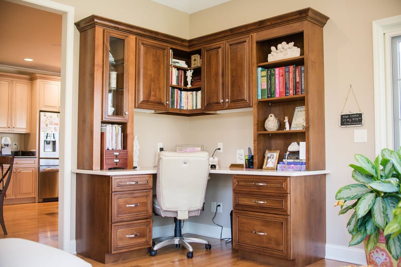 Custom home office with L-shaped desk in sunroom addition by Peacock & Company