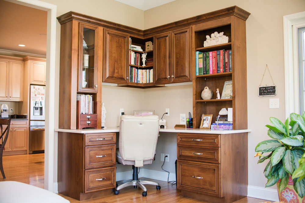 Custom home office with L-shaped desk in sunroom addition by Peacock & Company