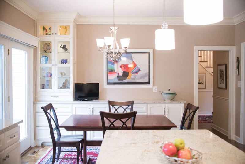 Dining room area in South Bend remodel with glass case of children's items