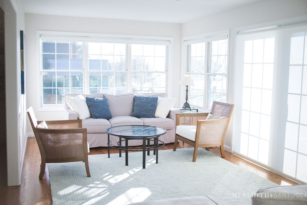 Two chairs and couch around coffee table in sunroom addition in Granger, IN