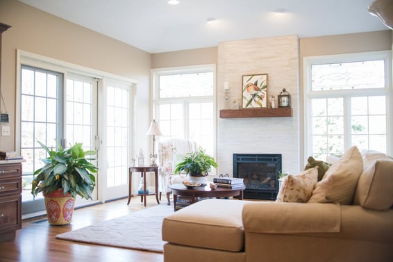 Four-season sunroom interior with white French doors to yard by Peacock & Company