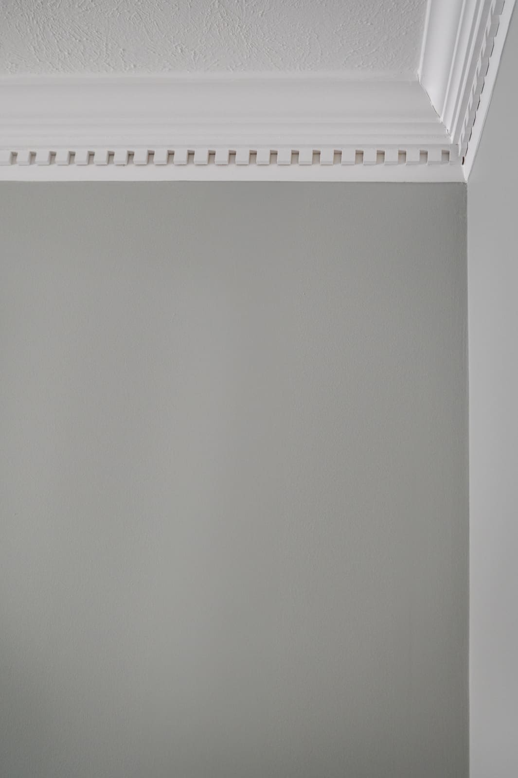 Crown molding detail on soft gray dining room wall in a Granger, IN home.