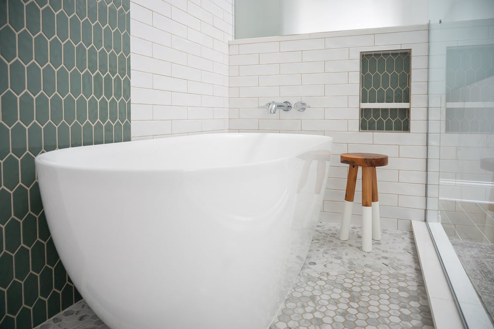 Green and white tile tub and shower combo in South Bend, IN bathroom remodel by Peacock & Company
