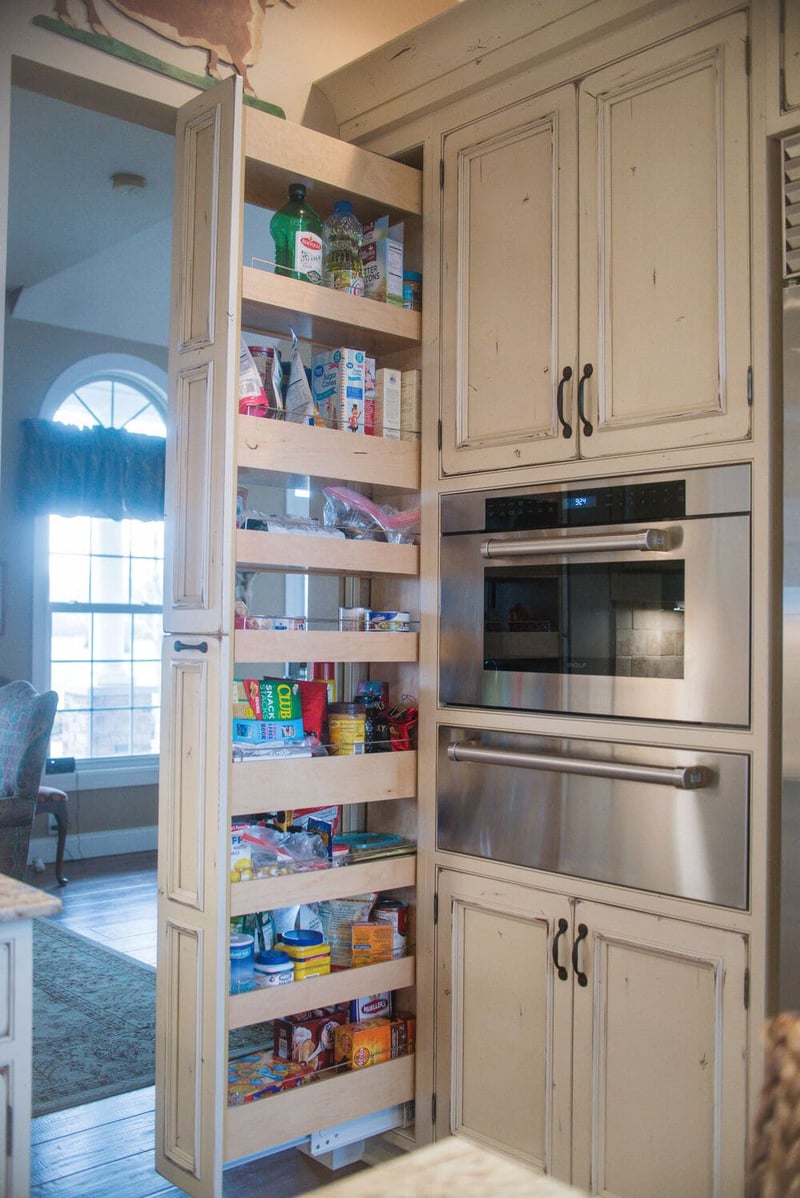 Hidden kitchen pantry door next to oven in South Bend, IN home remodel