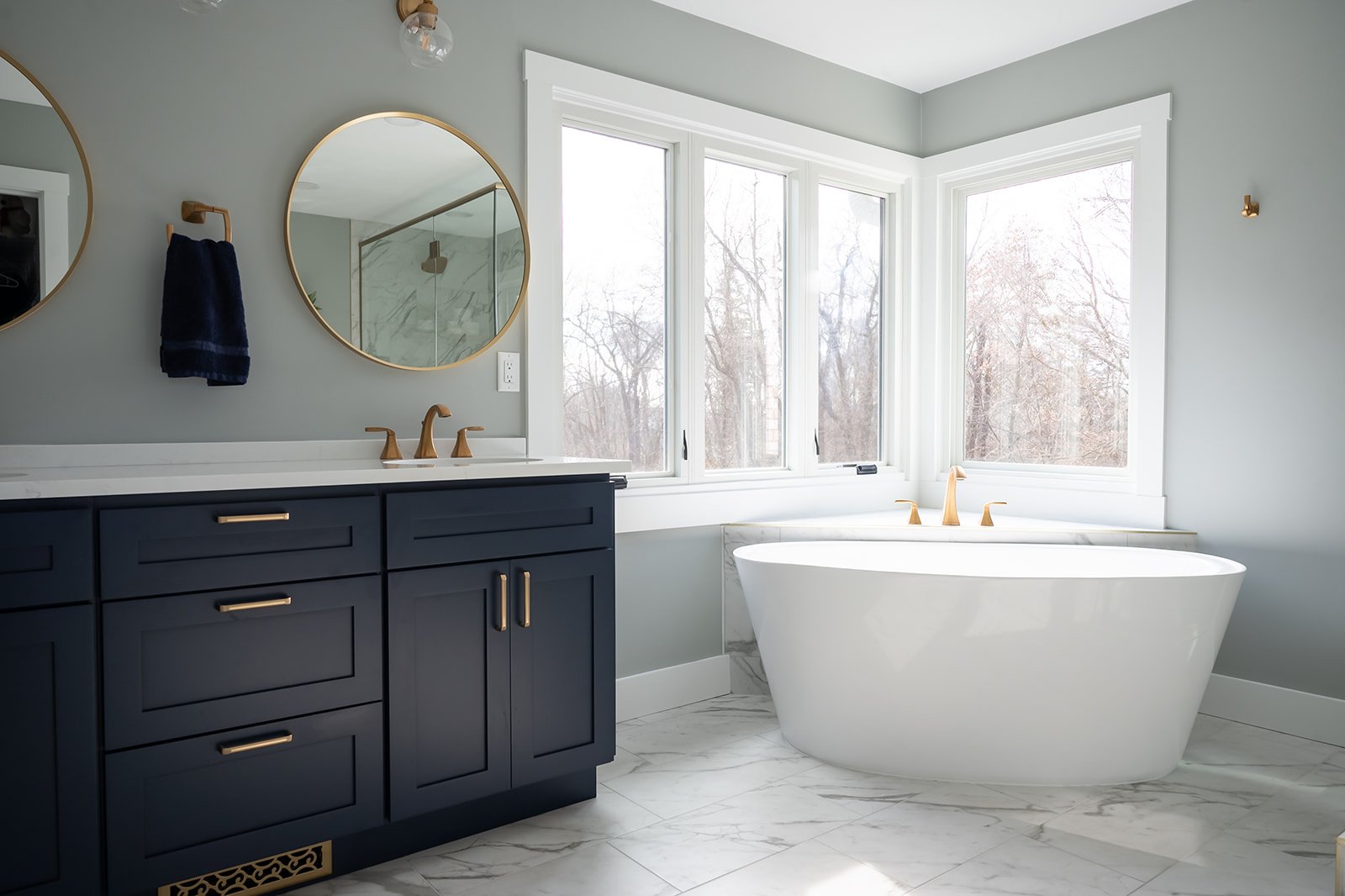 Luxury bathroom remodel with porcelain tub below window near Harbour Country, MI by Peacock and Company