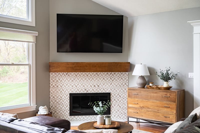 Modern South Bend living room remodel with fireplace and wooden mantel below TV