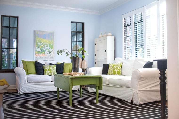 Modern living room area with green accents and custom windows-1