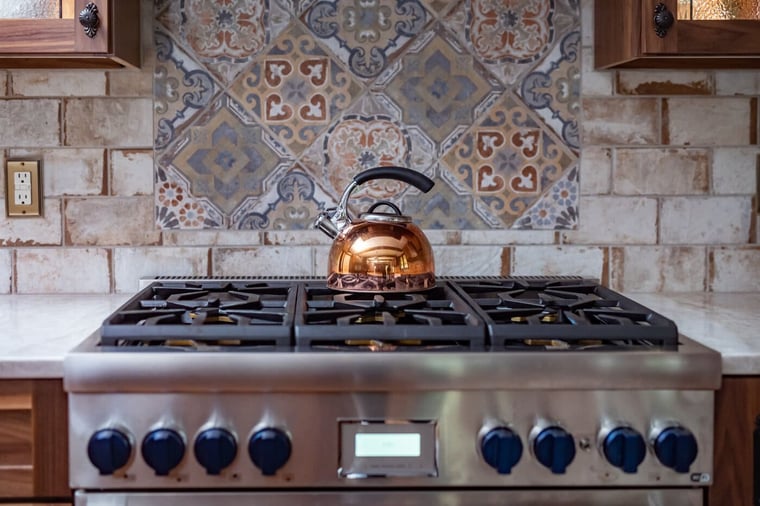 Mosaic pattern backsplash square behind stainless steel stove top in South Bend kitchen