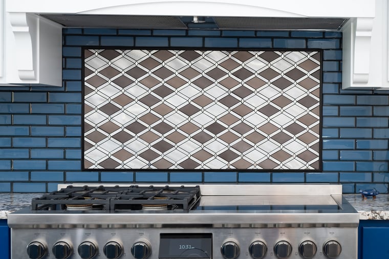 Mosaic tile backsplash behind stove in South Bend kitchen remodel by Peacock & Company