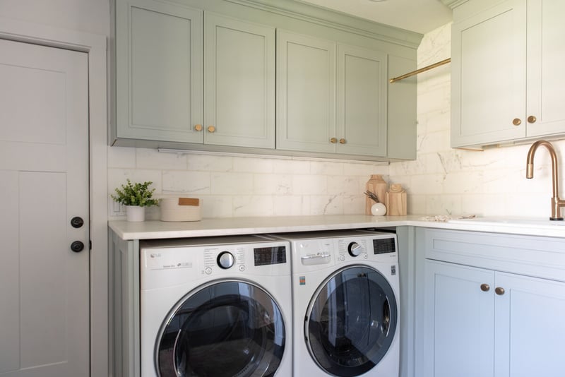 Mudroom addition near South Bend, Indiana with farmhouse style cabinetry and brass fixtures 