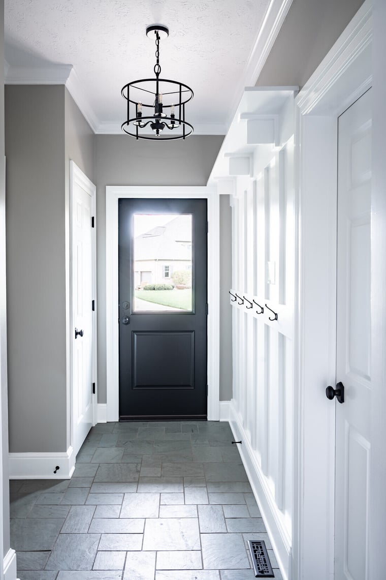 Mudroom breezeway renovation with built-in hooks in South Bend by Peacock & Company