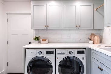 Mudroom renovation with washer and dryer beneath custom cabinetry in Greater Michiana