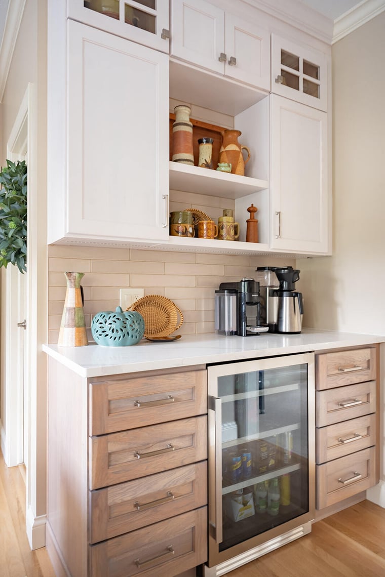 Peacock & Co.- kitchen remodel in South Bend, beverage station with fridge, natural wood drawers with brass handles, white upper cabinetry with silver pulls, open shelving, glass front cabinet doors, mixed metals