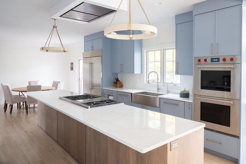 Two-tone blue and white kitchen remodel by Peacock and Company with island