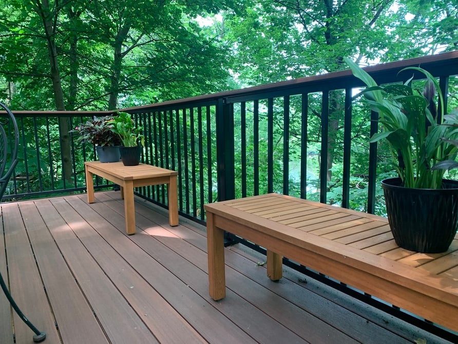 Deck in South Bend, IN with black railing and benches with plants by Peacock