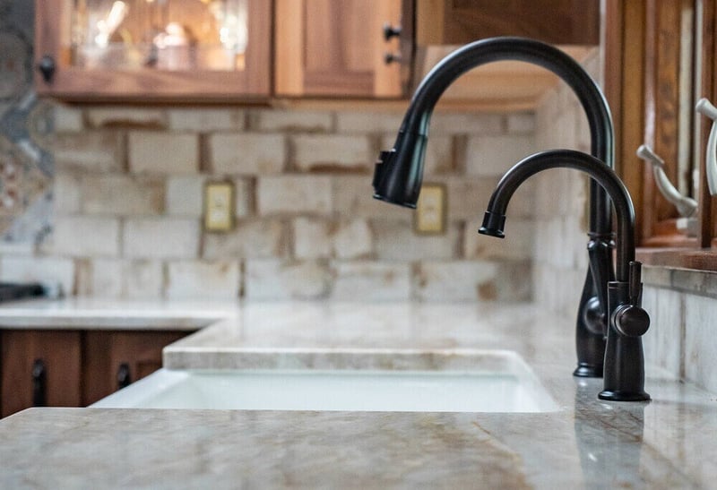 Quartz countertops and black faucet in South Bend, IN kitchen remodel by Peacock & Company