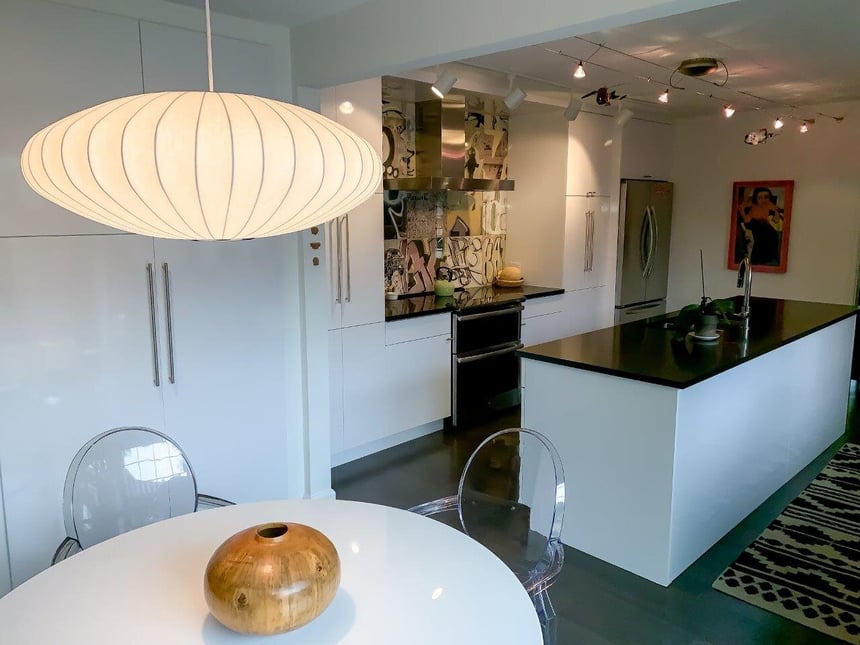 Luxury modern kitchen in South Bend with light fixture above dining table