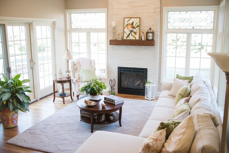 Sunroom addition with fireplace and natural stone surround with French doors to backyard