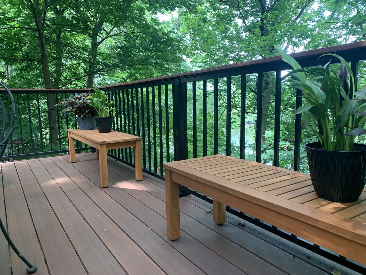 Plants on benches near railing on raised deck in South Bend, IN by Peacock and Company