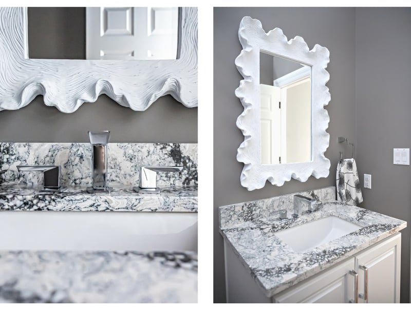 Powder room remodel in Granger, Indiana with black and white stone countertops and stainless steel faucet