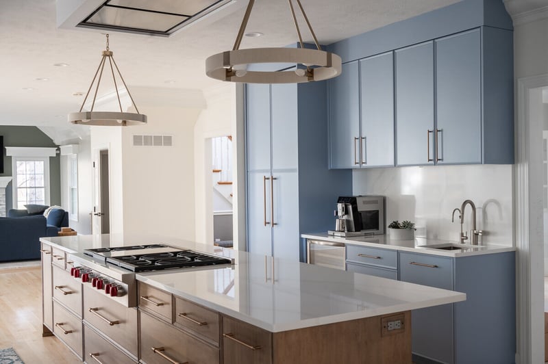 Blue high-end kitchen remodel in South Bend, IN with island and cooktop by Peacock & Company