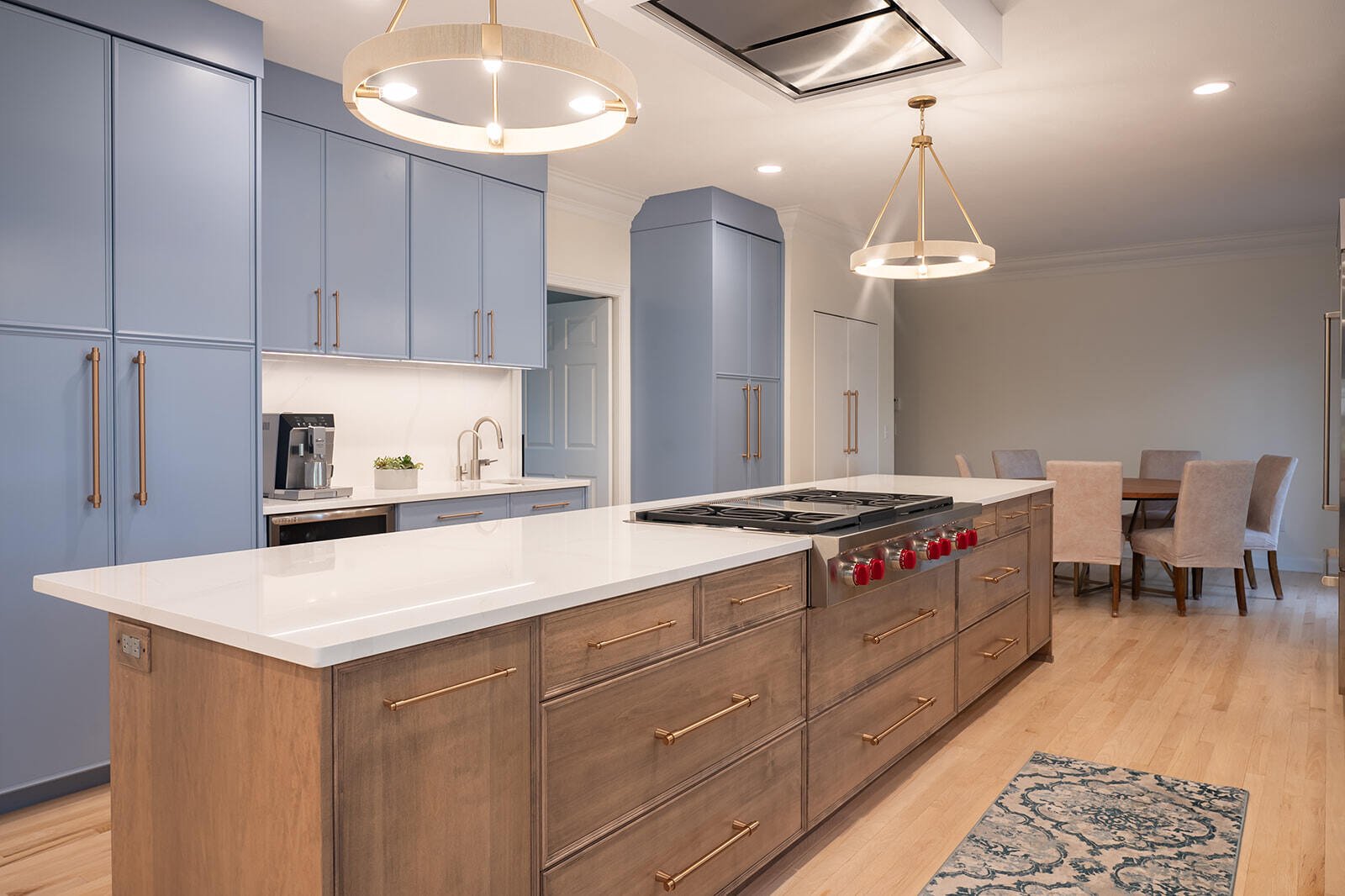 Island with base cabinetry and stove top in South Bend, IN kitchen remodel by Peacock & Company