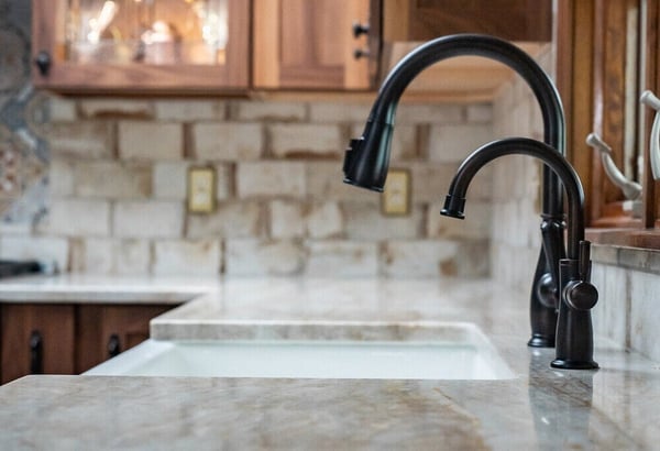 Quartz countertops and black faucet in South Bend, IN kitchen remodel by Peacock & Company