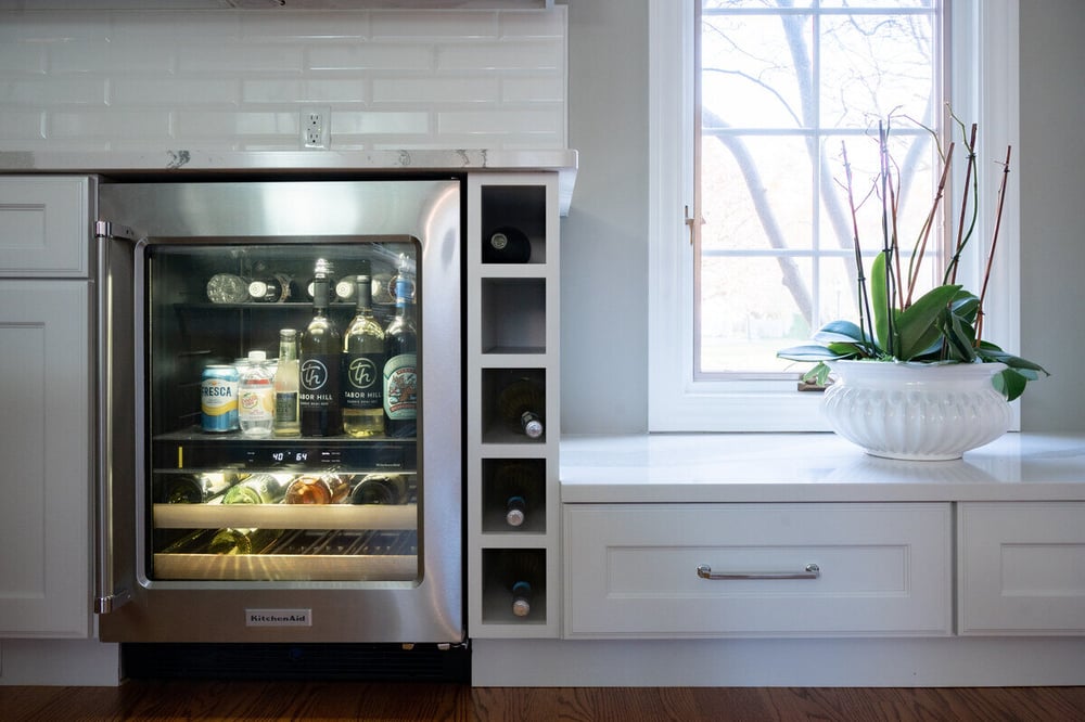 Stainless steel beverage fridge with built-in wine bottle shelving