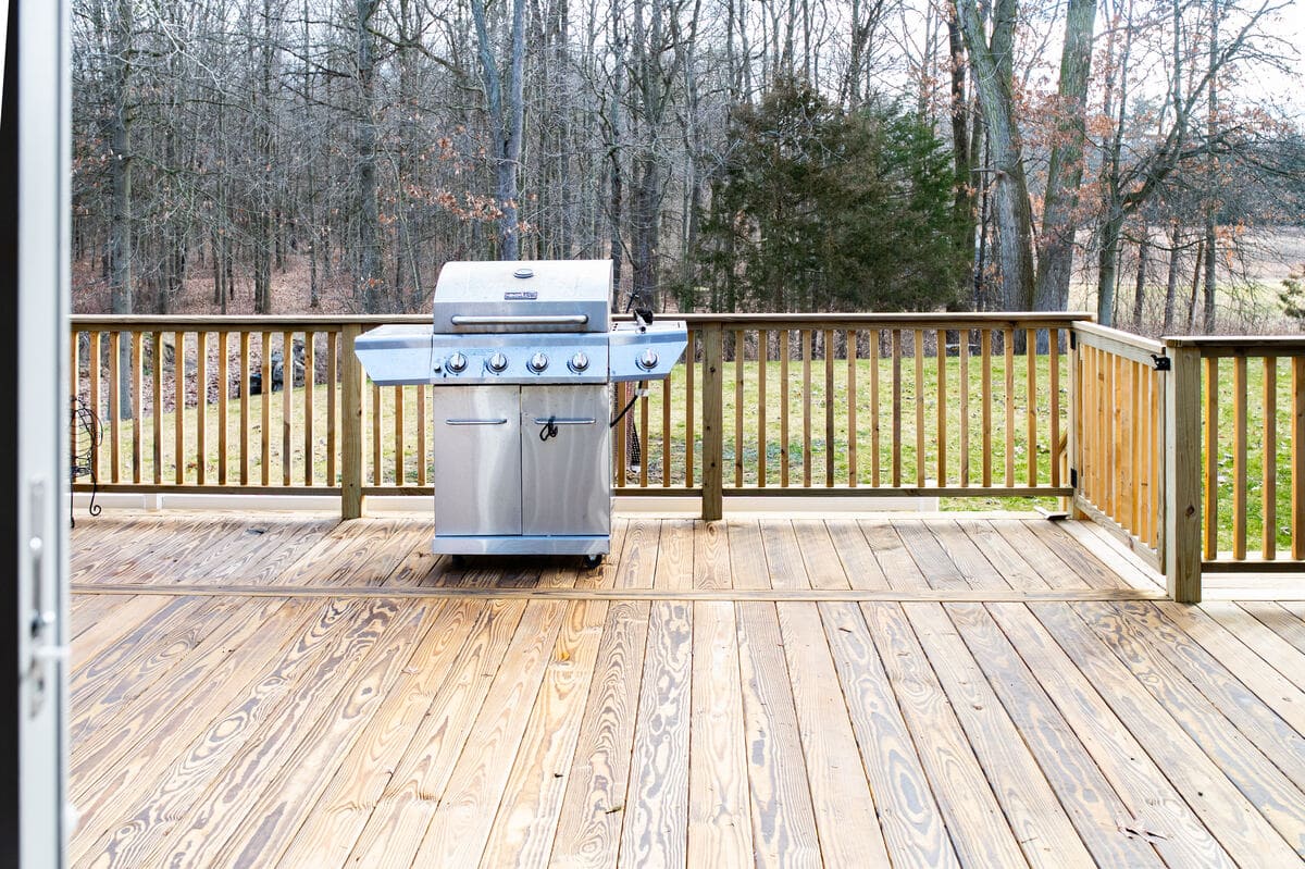 Stainless steel grill on wood deck in South Bend, IN by Peacock & Company