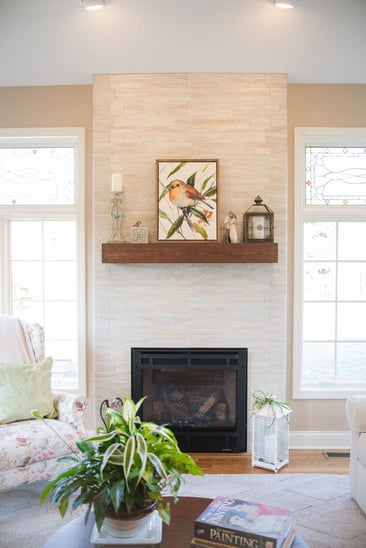 Sunroom addition with fireplace and stone surround by Peacock & Company
