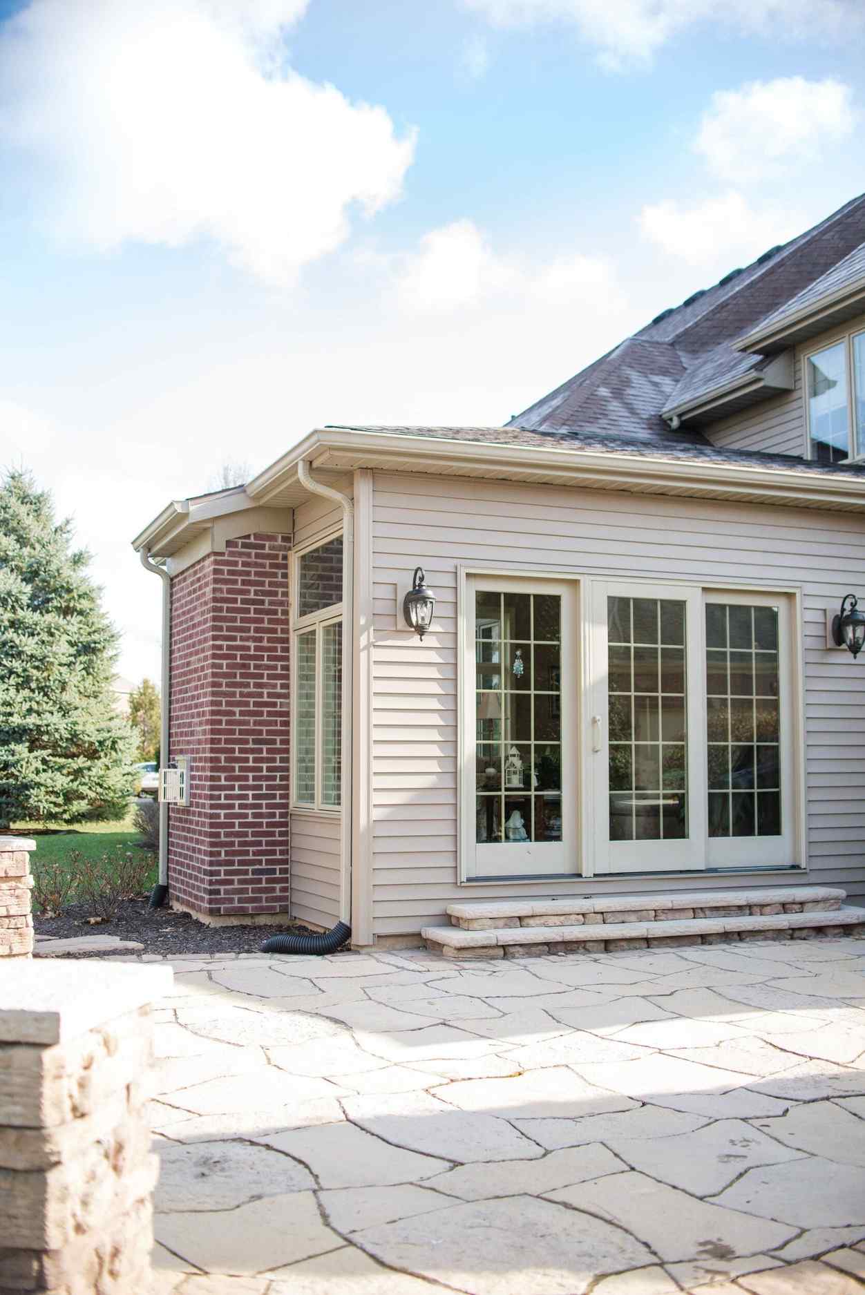 Exterior of Sunroom and Concrete Patio Connected to Addition