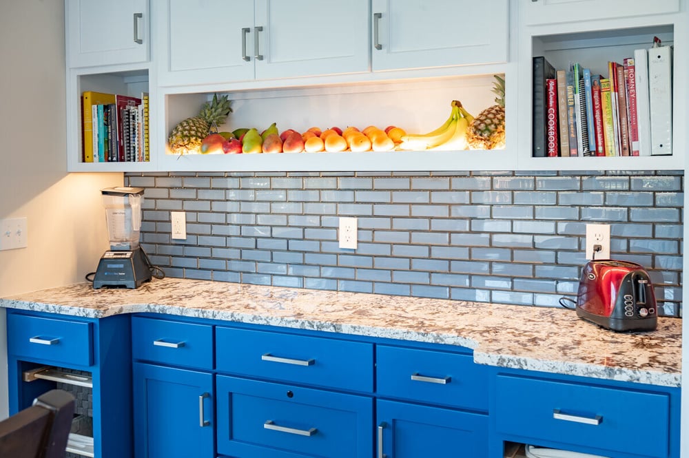 Task lighting in front of blue subway tile backsplash in South Bend, IN kitchen remodel by Peacock and Company