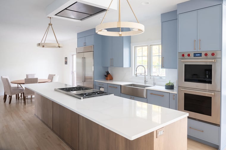 Two-tone blue and white kitchen remodel by Peacock and Company with island