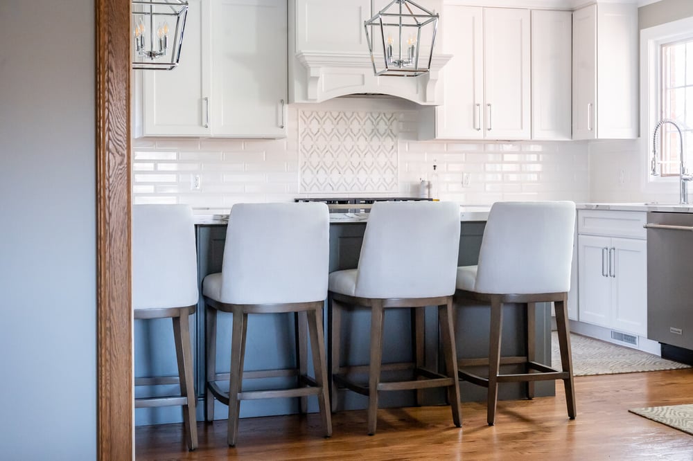 White kitchen remodel in South Bend with subway and mosaic tile backsplash and island