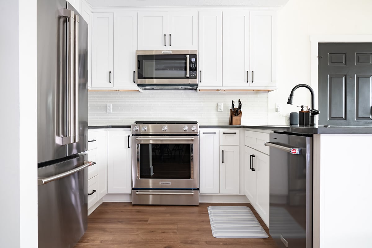 White kitchen remodel with shaker-style cabinets by Peacock & Company