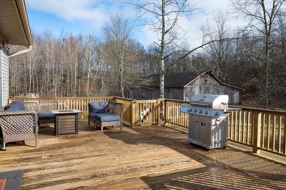 Wood backyard deck in South Bend with grill and fire pit by Peacock & Company