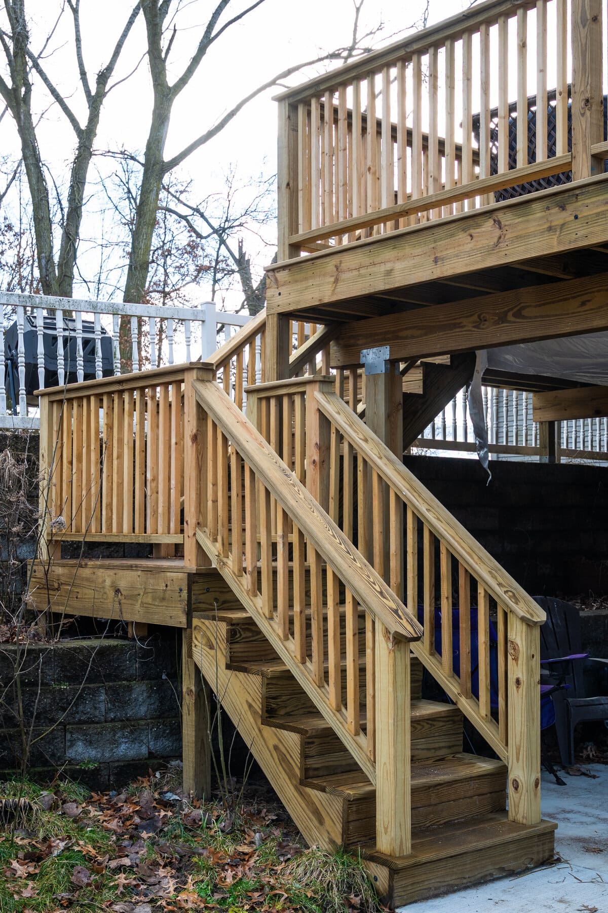 Wood steps and railing leading to raised deck in South Bend, IN by Peacock & Company