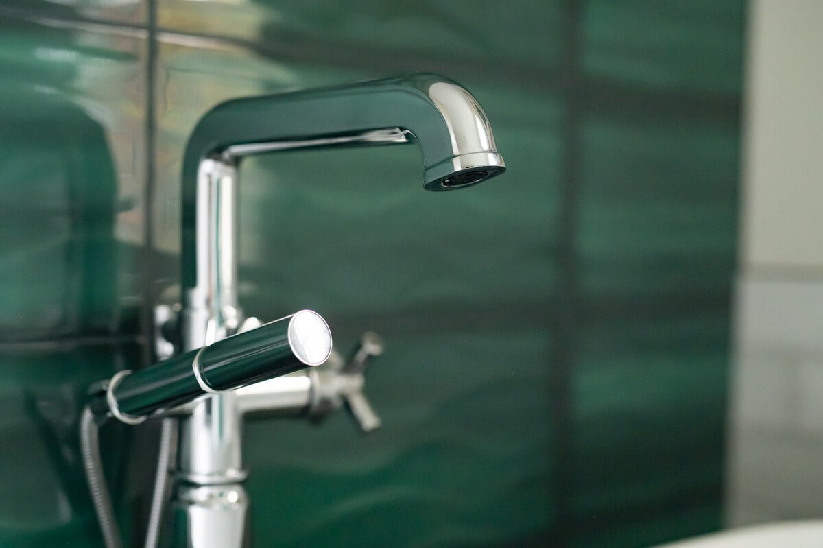 Close up of silver faucet in bathroom remodel in South Bend by Peacock & Co.