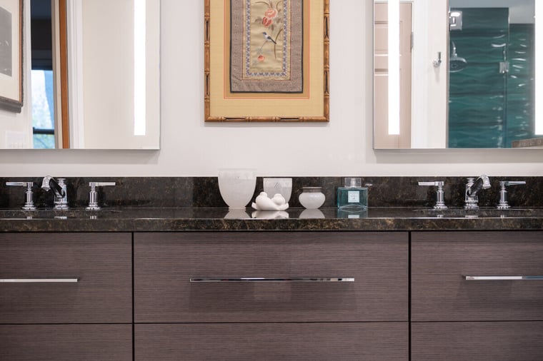 Double vanity with backlit mirrors and stainless steel faucets in South Bend bathroom remodel by Peacock and Company