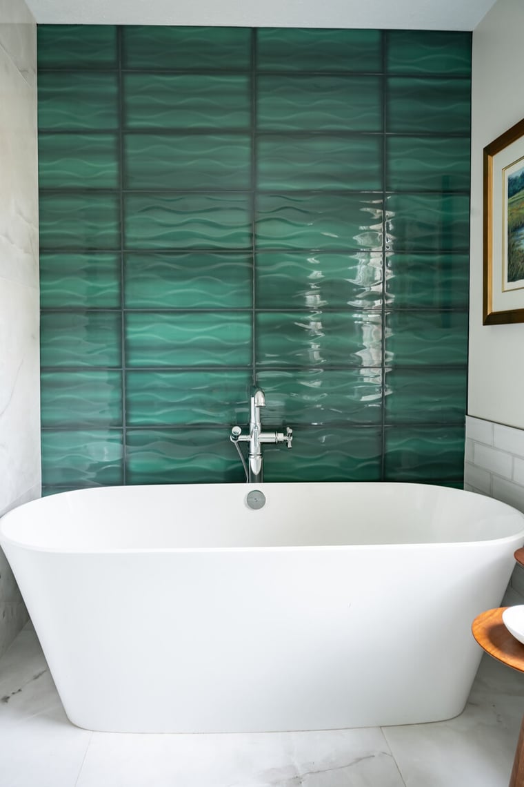 Peacock & Co. South Bend wavy green accent tile wall behind freestanding soaking tub